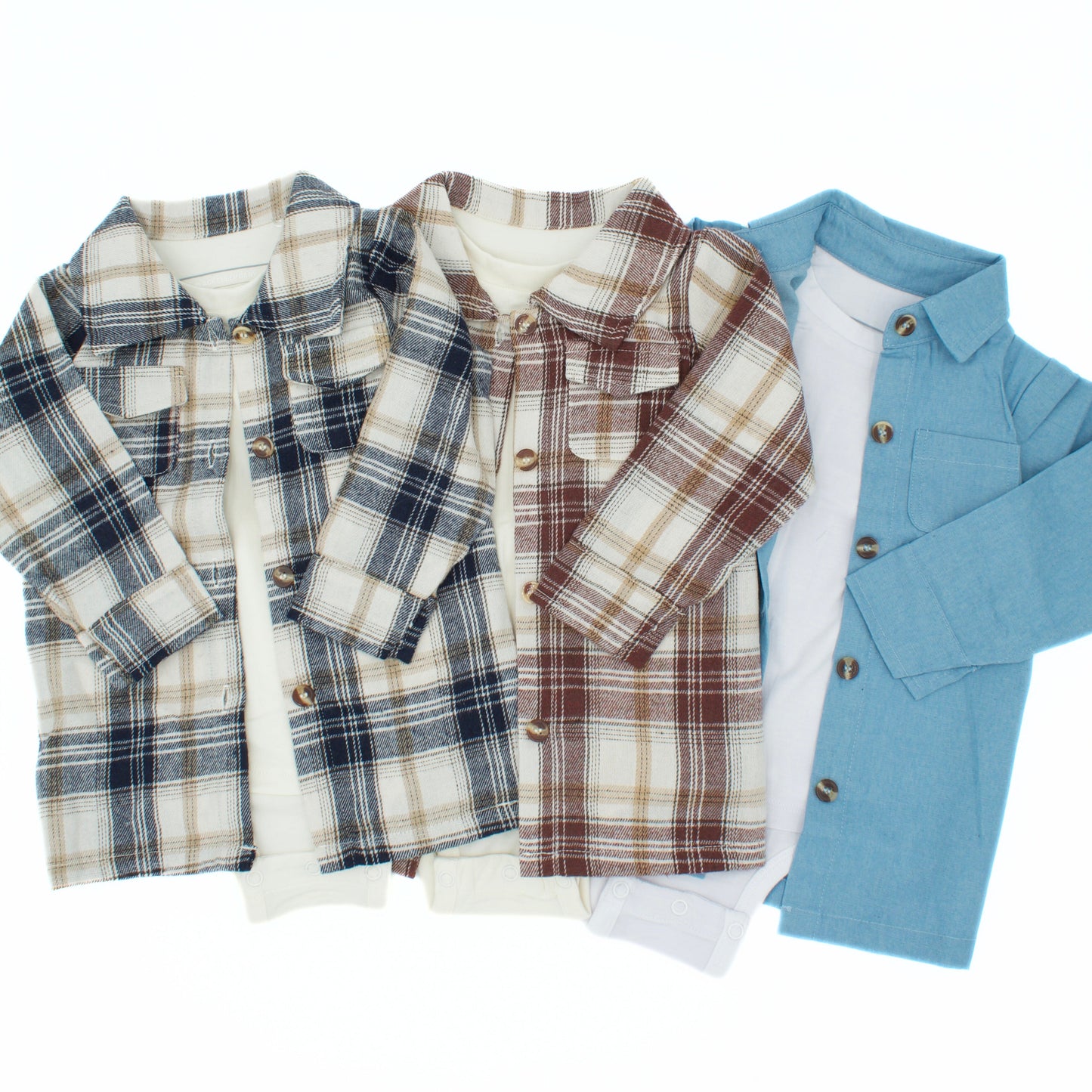 Two baby boy flannel shirts attached to a bamboo baby onesie and a denim blue overshirt with an attached white bamboo onesie on a white background