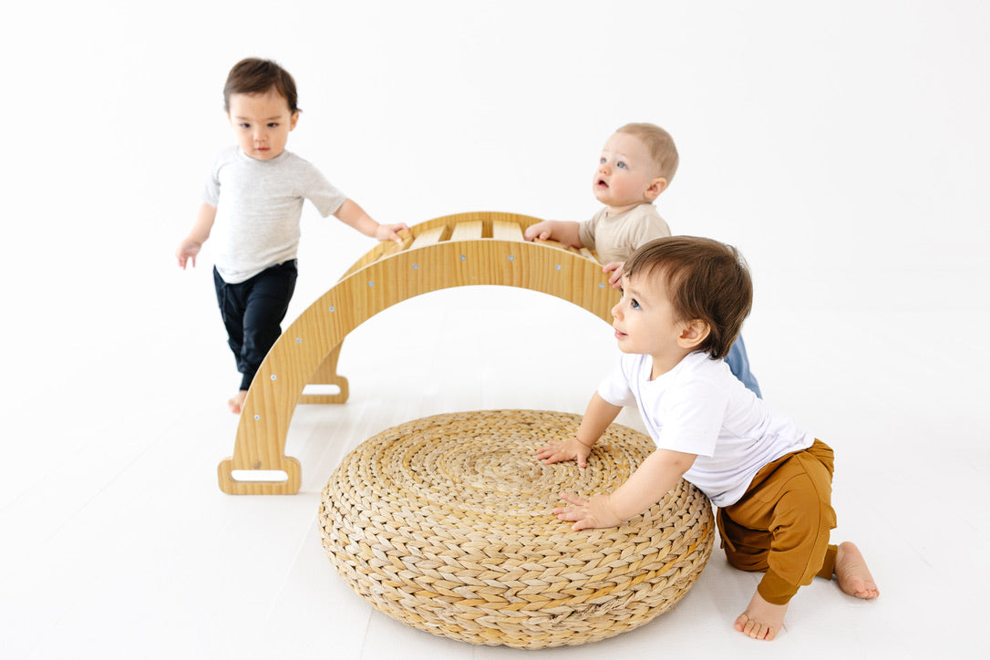 Four children wearing purple, cream, pink and green bamboo sets