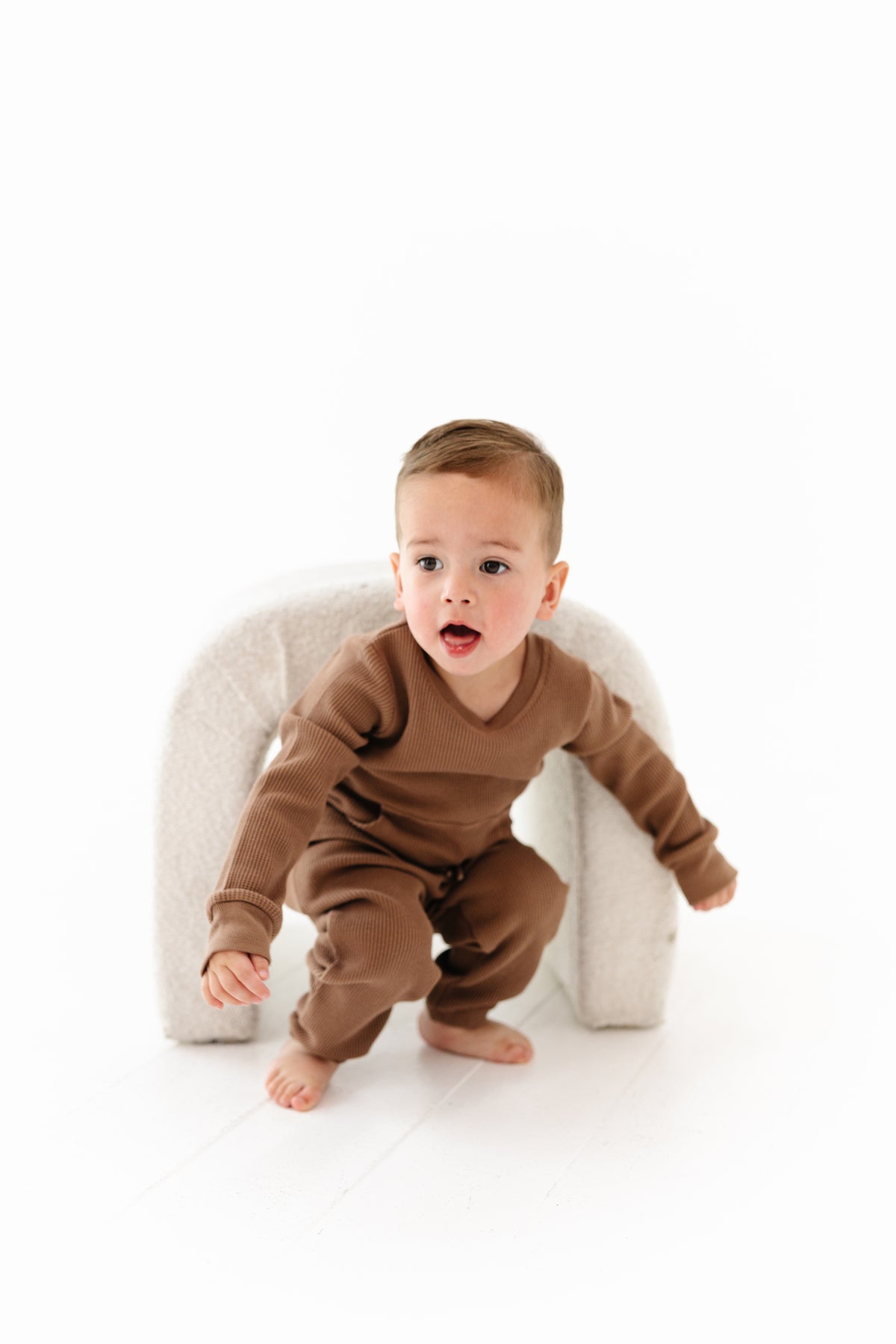 Child wearing a pink sweatshirt and pants set