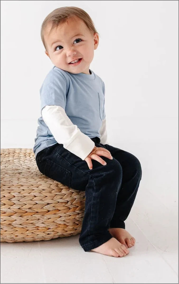 Child wearing a blue Black Sheep Baby onesie