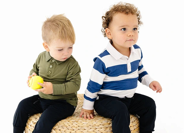 Two children wearing olive and striped polos