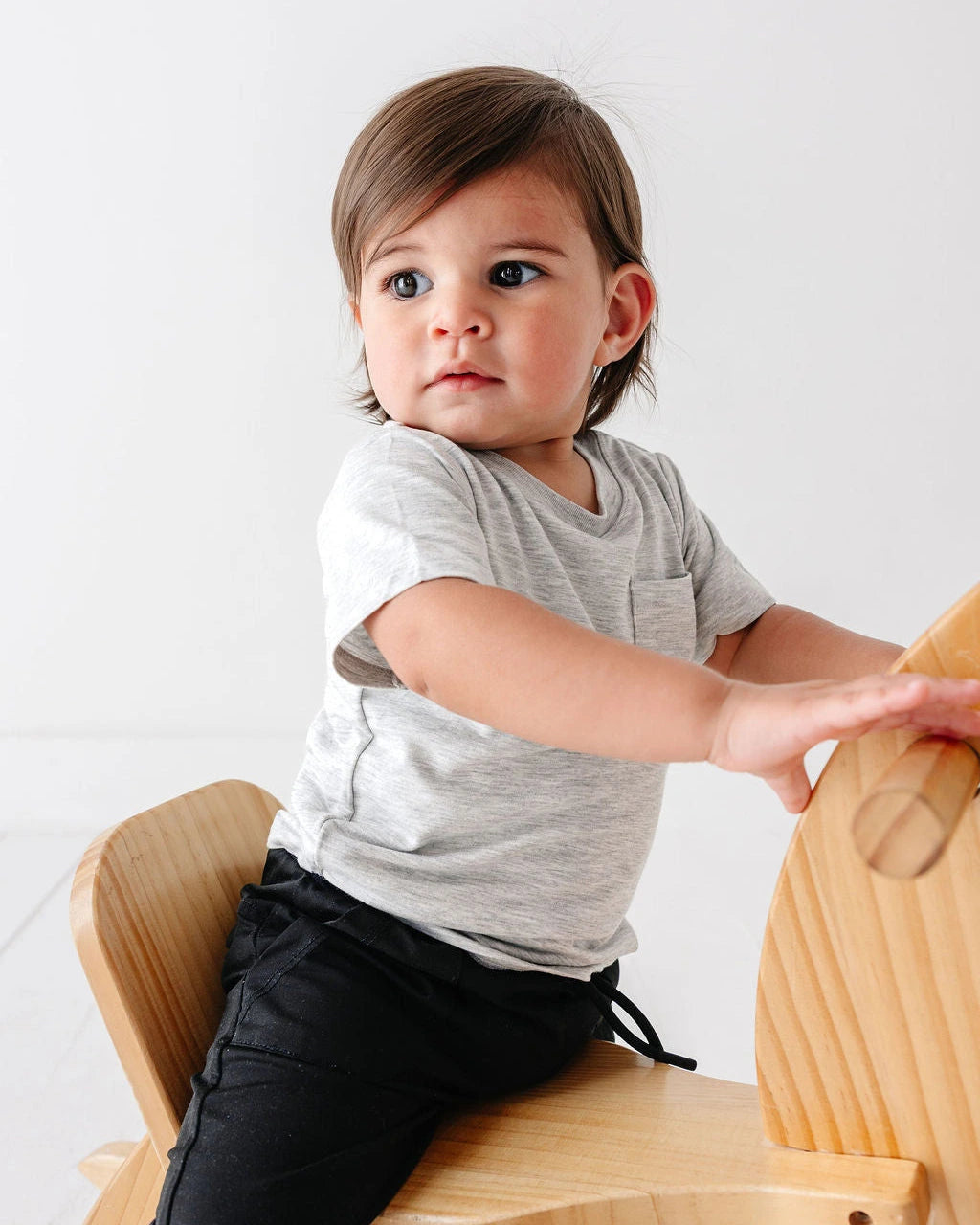 Child wearing a gray Onesie Tee