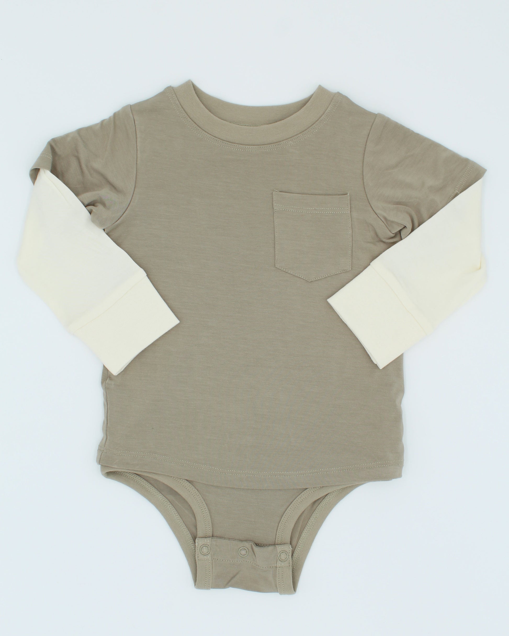 Stone colored baby onesie with cream sleeves on a white background