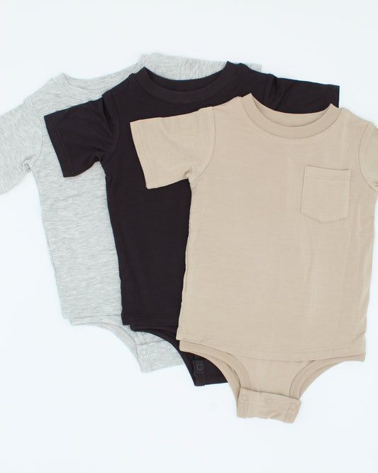 Three baby bodysuits in black, gray, and beige on a white background